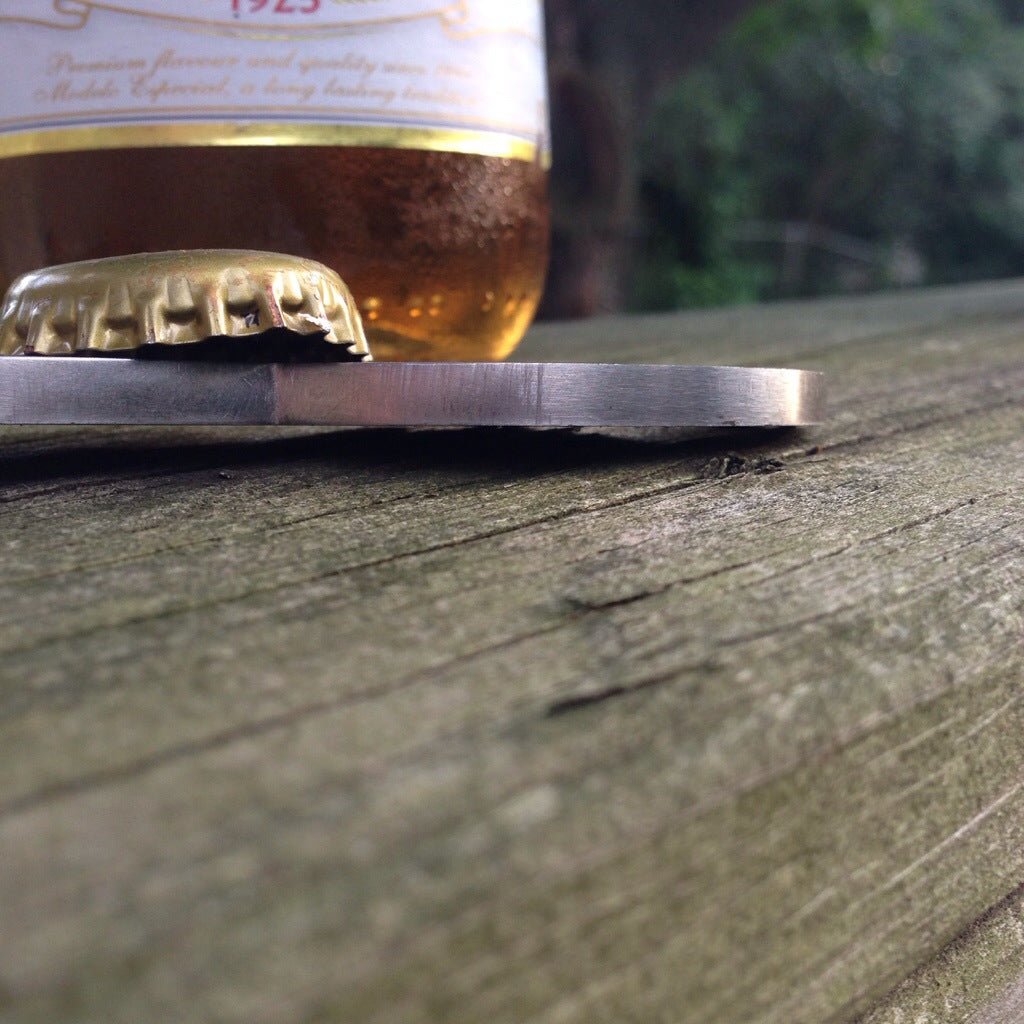 Close up of mustache bottle opener on railing
