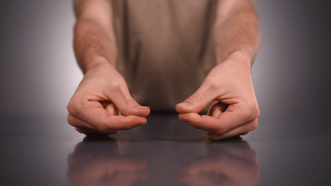 Roll moustache wax between thumb and forefinger until soft and pliable