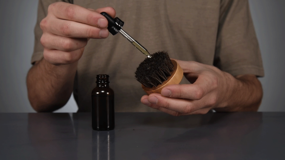 Apply beard oil to your beard oil brush
